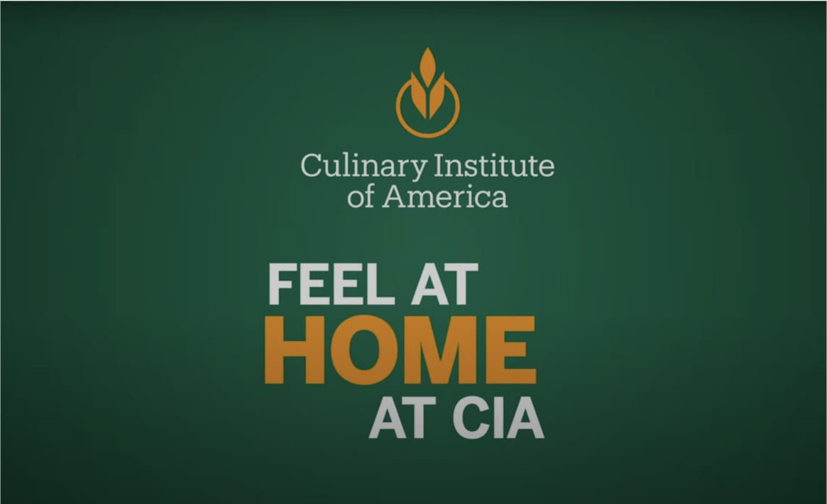 A green background displays the "Culinary Institute of America" logo, which consists of a stylized flame. Below the logo, white and orange text reads, "Feel at Home at CIA.