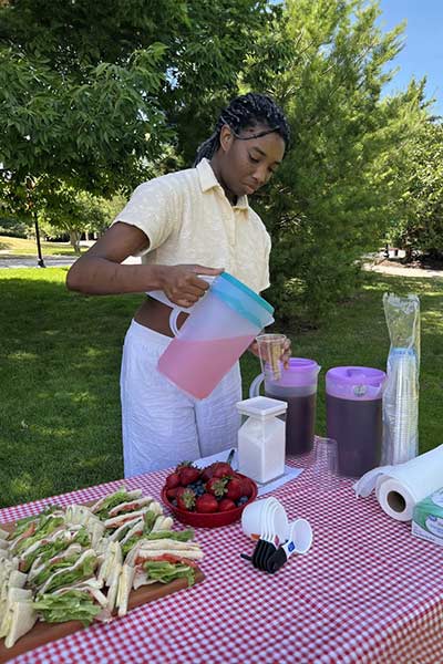 Club Spotlight: Teapot Club and Outdoors Club - CIA Student Pouring Drinks